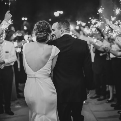 Husband and wife leave their reception to a sparkler exit from the Greenville Country Club.
