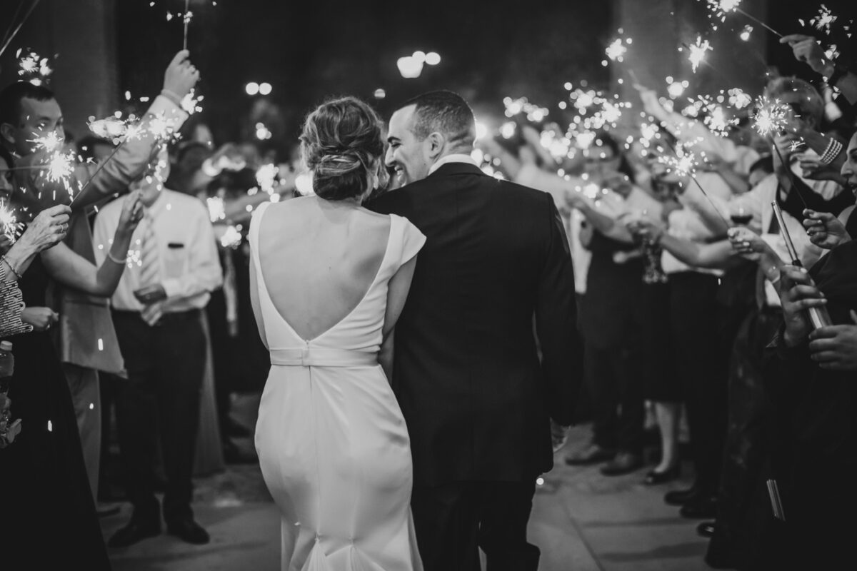 Husband and wife leave their reception to a sparkler exit from the Greenville Country Club.