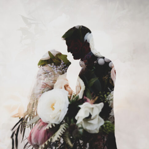 A double exposure of the bridal bouquet overlaid on a silhouette of a wedding couple.