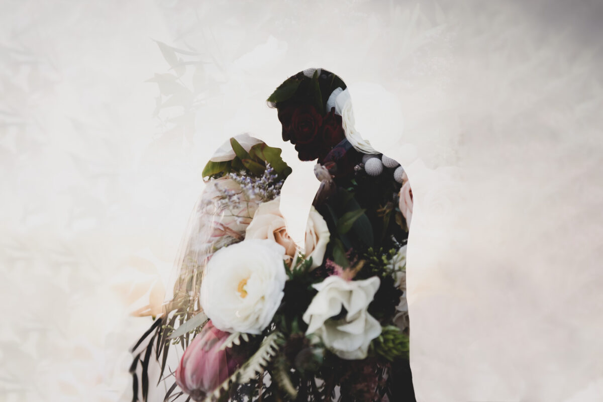 A double exposure of the bridal bouquet overlaid on a silhouette of a wedding couple.