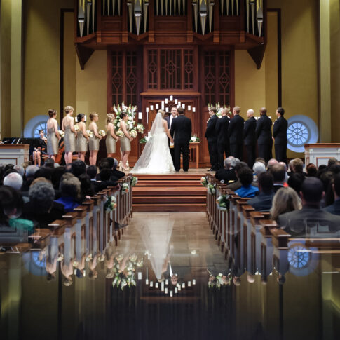 A serene moment at the altar where the bride and groom pay close attention to the words of the officiator.