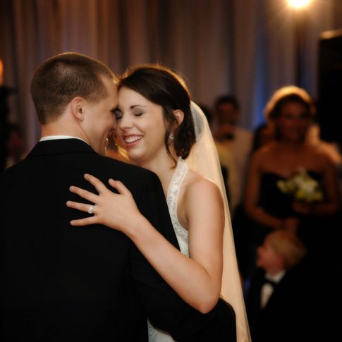 During a first dance in the Hyatt Hotel in Greenville, SC a bride and groom share a moment of laughter.