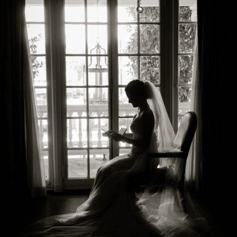 A bride peruses the letter written to her by her groom while getting ready.