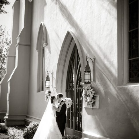 A couple kisses on the steps of St. Johns Episcopal Chapel in Montgomery, Alabama.