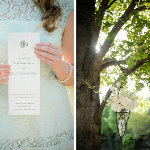 A detail shot of the delicate script of a wedding invitation paired with a white floral arrangement hanging from a tree.