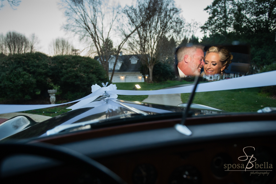 The newlyweds snuggling in the back seat of the Rolls, while I photographed them in the rearview mirror.