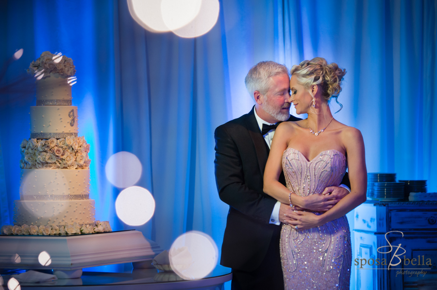 Dramatic uplighting (here seen in blue) add so much to the background of photos, and look at that incredible cake!