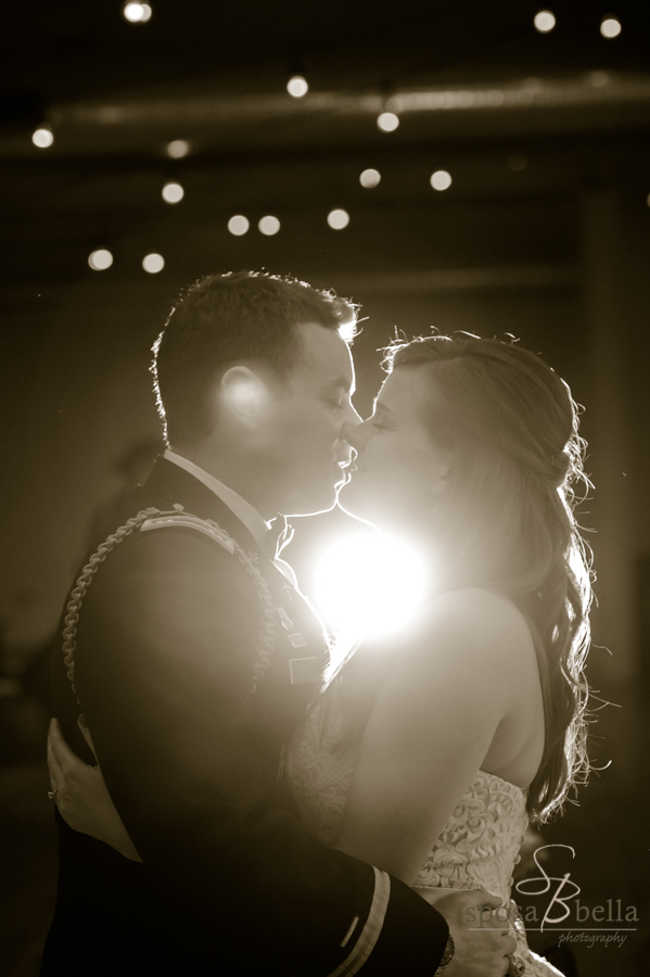 The moment before a kiss with the glow of the twinkle lights and our flash positioned behind the newlyweds.