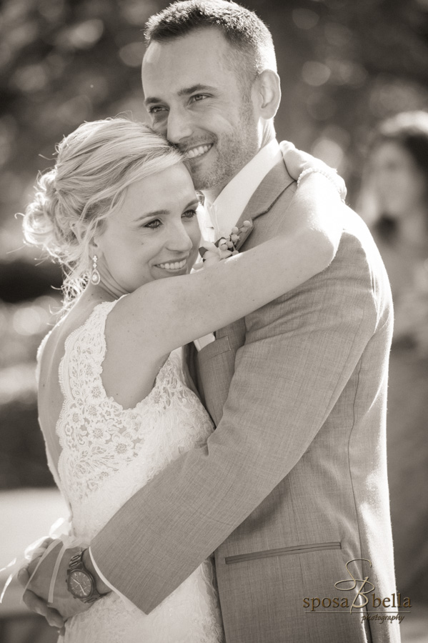 Newlyweds hug and smile after their wedding.