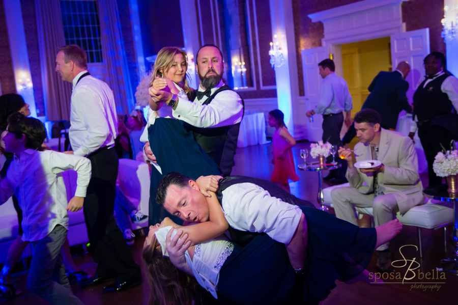 A groom dancing with his daughter.