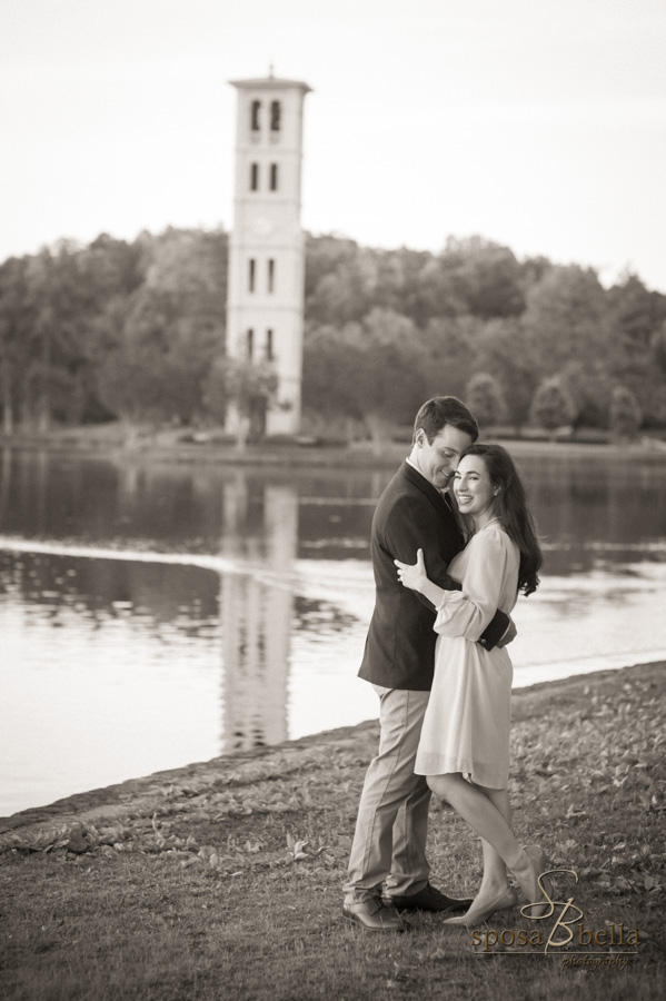 Engaged couple happily embraces with the Furman clock tower in the background. 