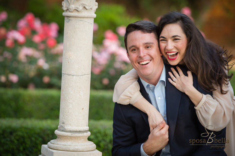 Couple laughs and embraces at the Furman Rose Garden. 