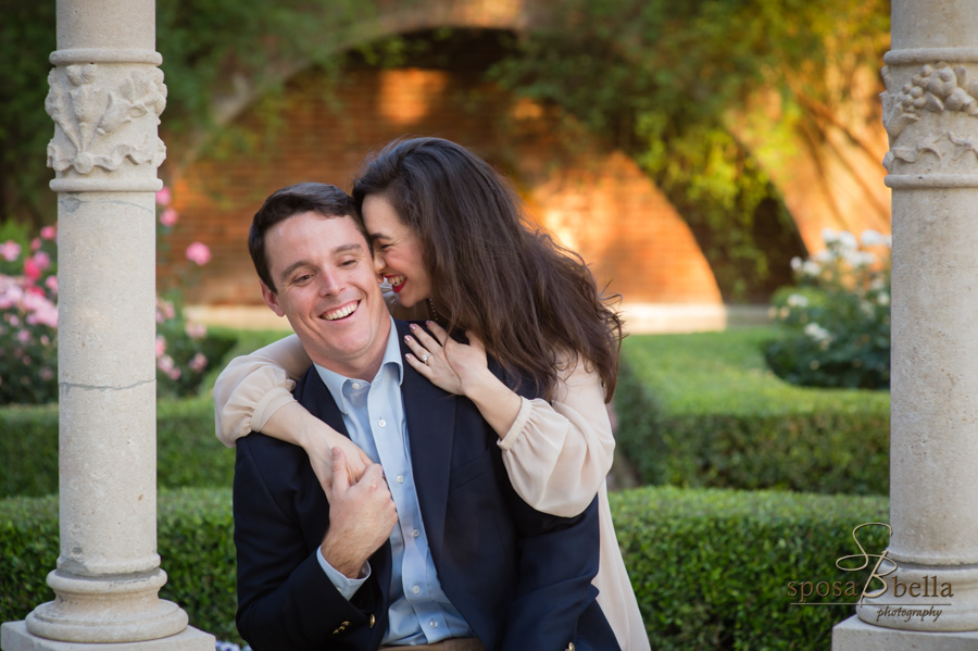 Bride-to-be embraces her fiance from behind. 