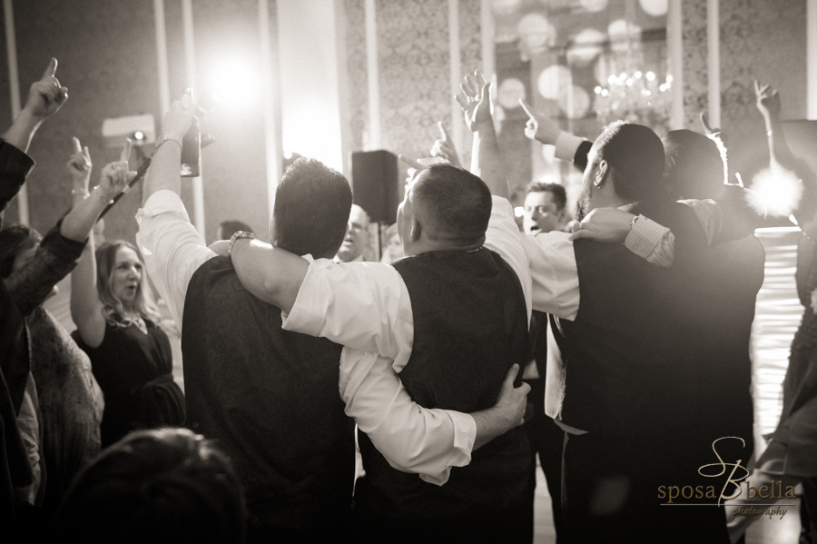 Groomsmen dancing and singing at the reception.