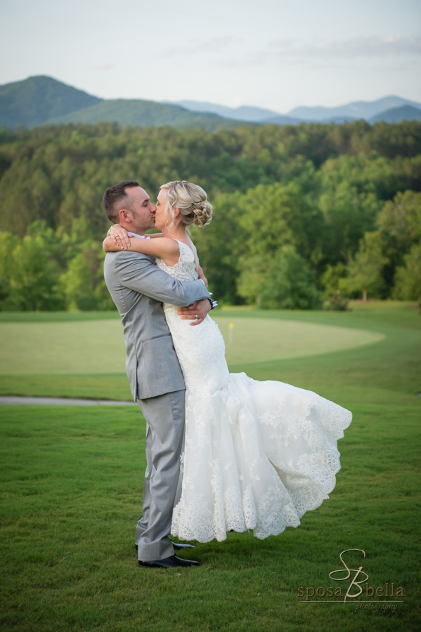 Bride and groom kiss with a views on the Blue Ridge mountains in the background.