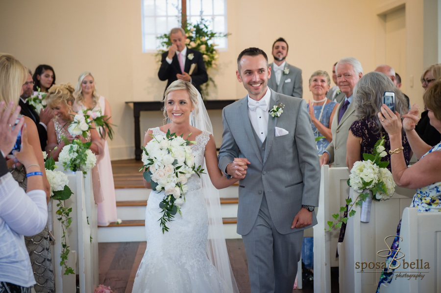 Bride and groom and exit the wedding ceremony chapel.