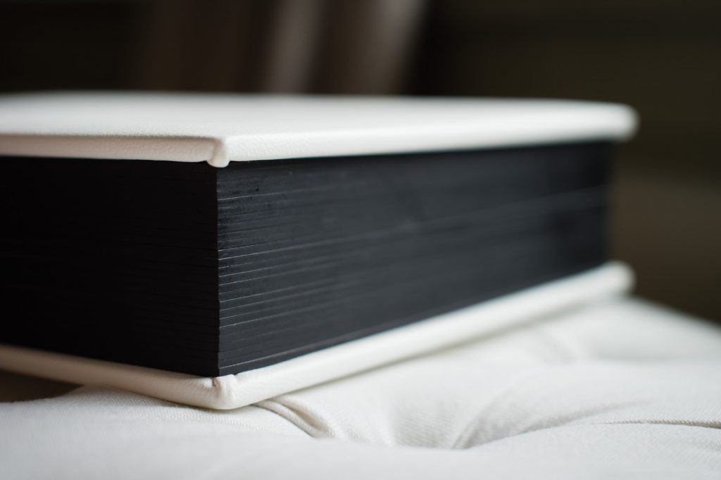 Close up detail of thick pages of matted wedding album.