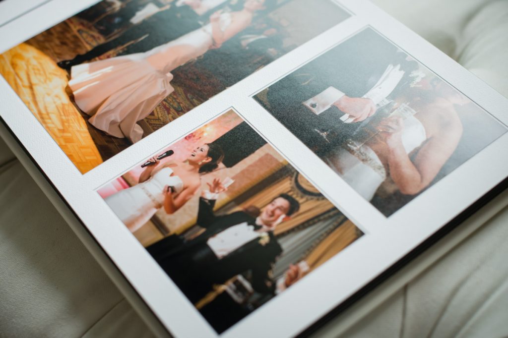 Up close detail of reception toasts in a matted wedding album.