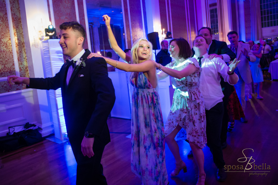 Conga line of guests at a wedding reception.