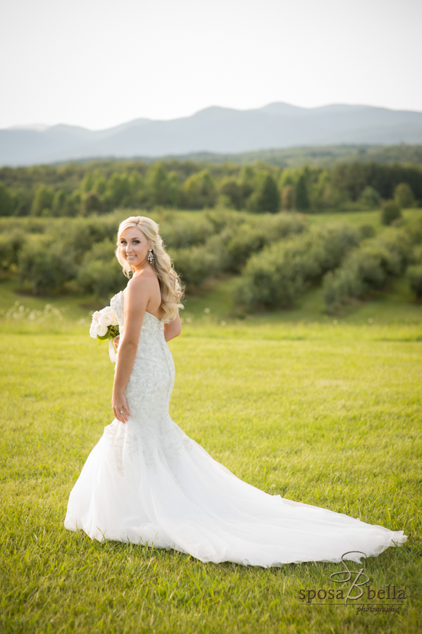 Bride walks along field at Chattooga Belle Farms. 