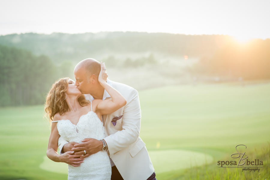 The bride and groom kiss on the beautiful Reserve golf course. 