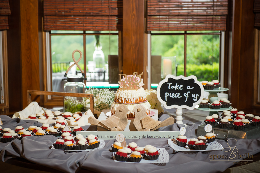 A dessert table, complete with a gold, sparkly Dr. and Mrs. sign on the cake. 