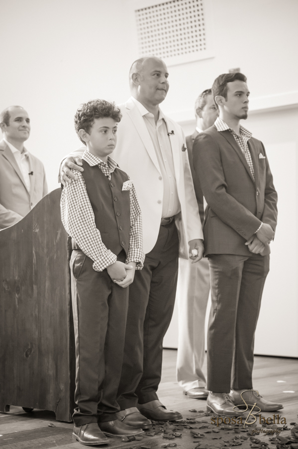 The groom and his two sons anxiously await the bride. 