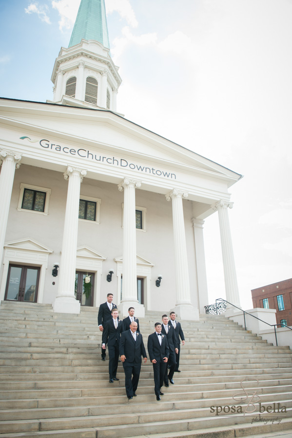 Groomsmen walking down steps in front of Grace Church, Downtown Greenville.