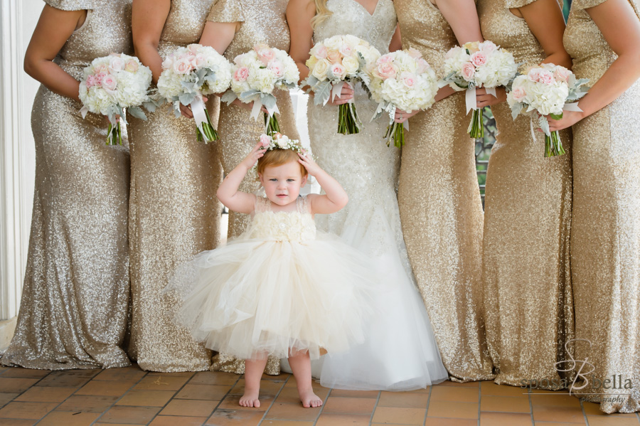 Flower girl in tutu standing in front of Bride and bridesmaids.