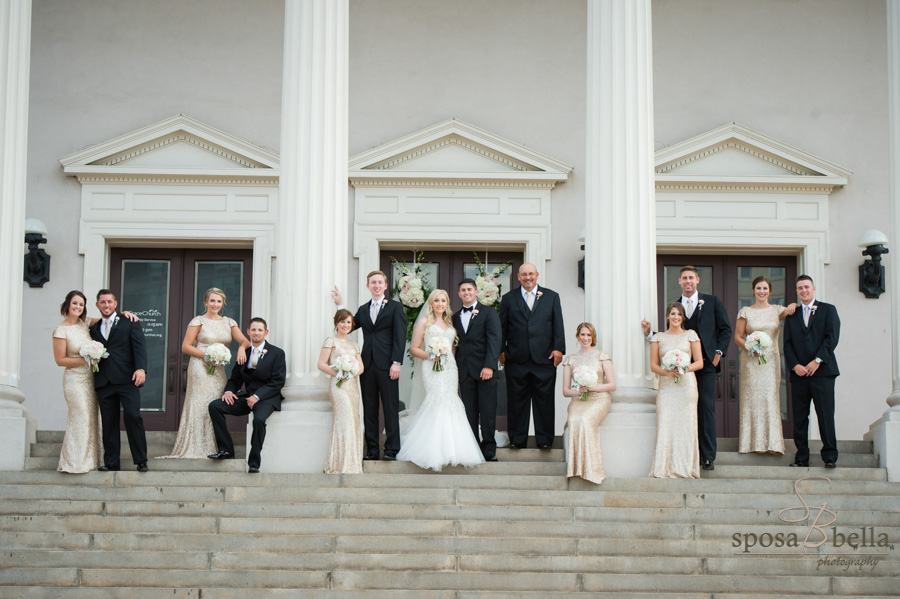 Wedding party posing for a photo in between the massive columns of Grace Church Downtown.