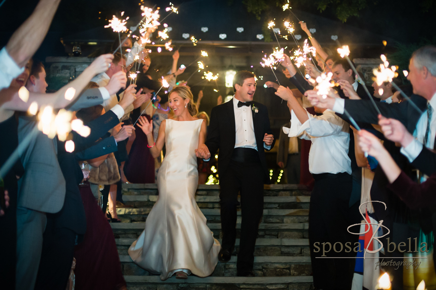 Leland and Charlie wave goodbye to their guests under a shower of sparklers.