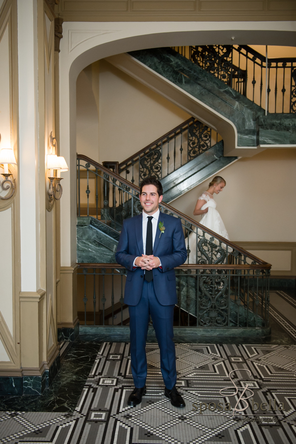 Bride descends staircase to her awaiting groom.