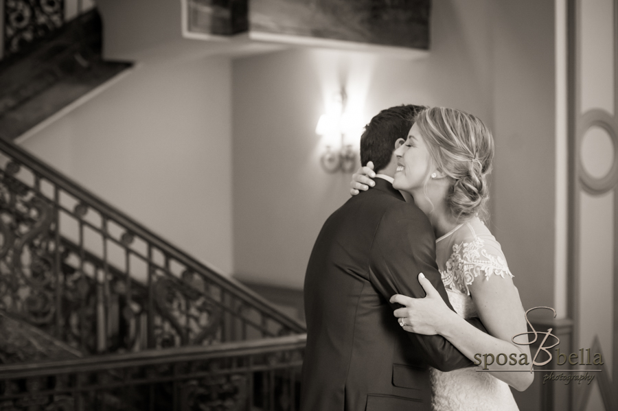 Black and white of bride and groom hugging.