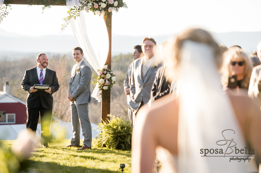 Bride walks down isle to her groom.