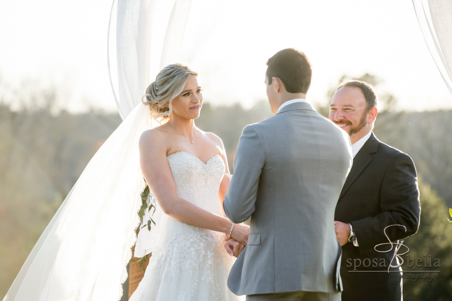 Bride stairs lovingly at groom during ceremony.