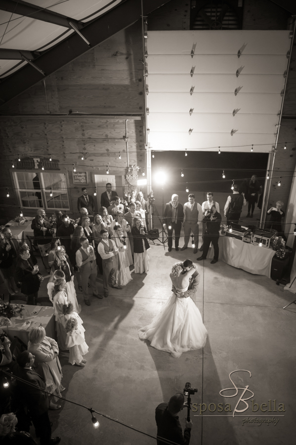 Happy newlyweds dance at their wedding reception.