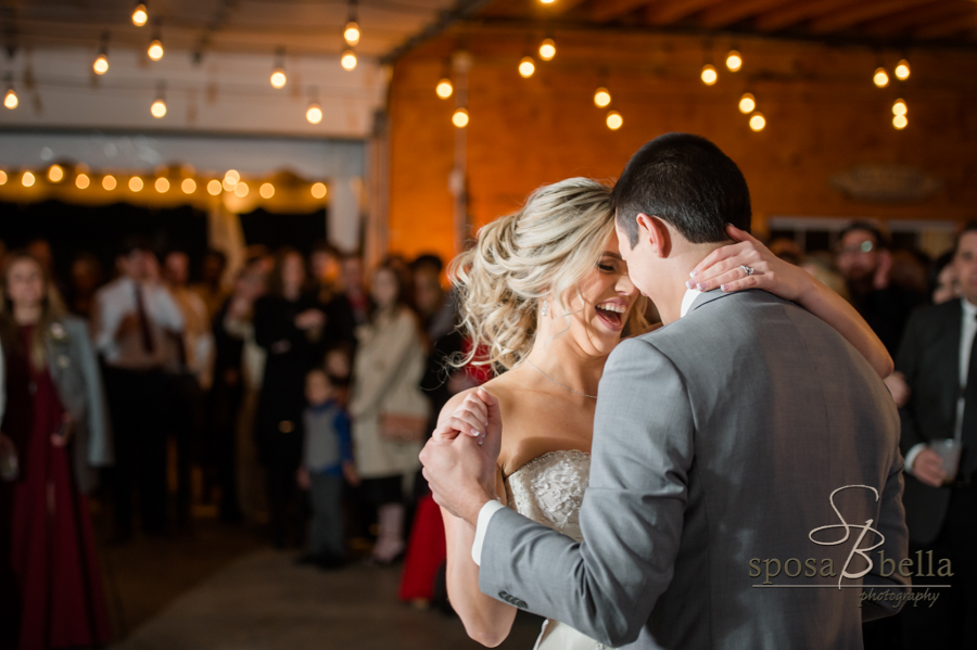 Happy newlyweds dance at their wedding reception.